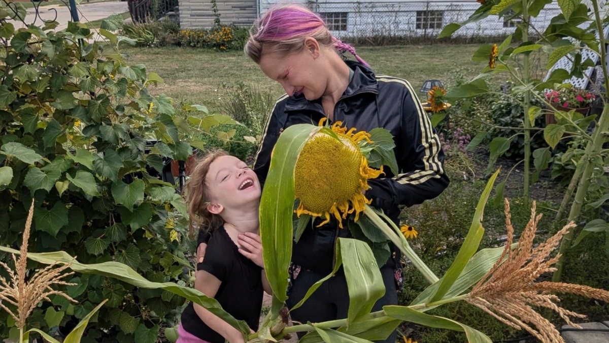 My daughter and I after harvesting a few Sunflowers 