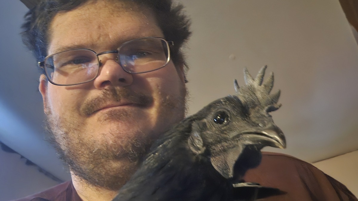 Shawn Dupee holding one of his Ayam Cemani roosters