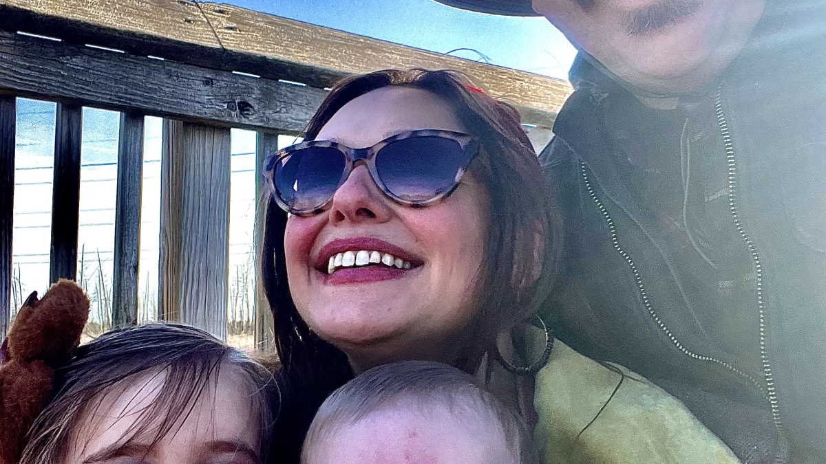 Mom and dad smiling with their small children