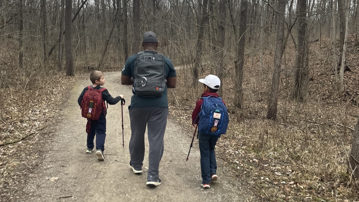 Dad teaching his little boys to love and respect the outdoors