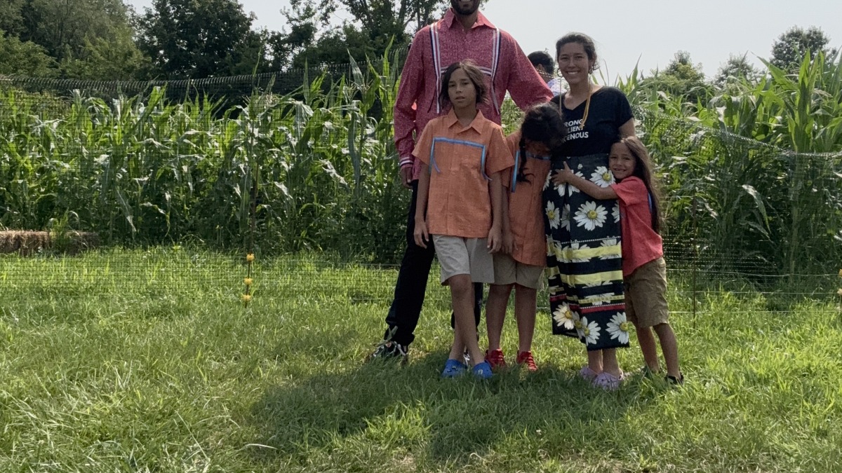 This is a picture of our family in front of our main field of corn, beans, and squash. 
