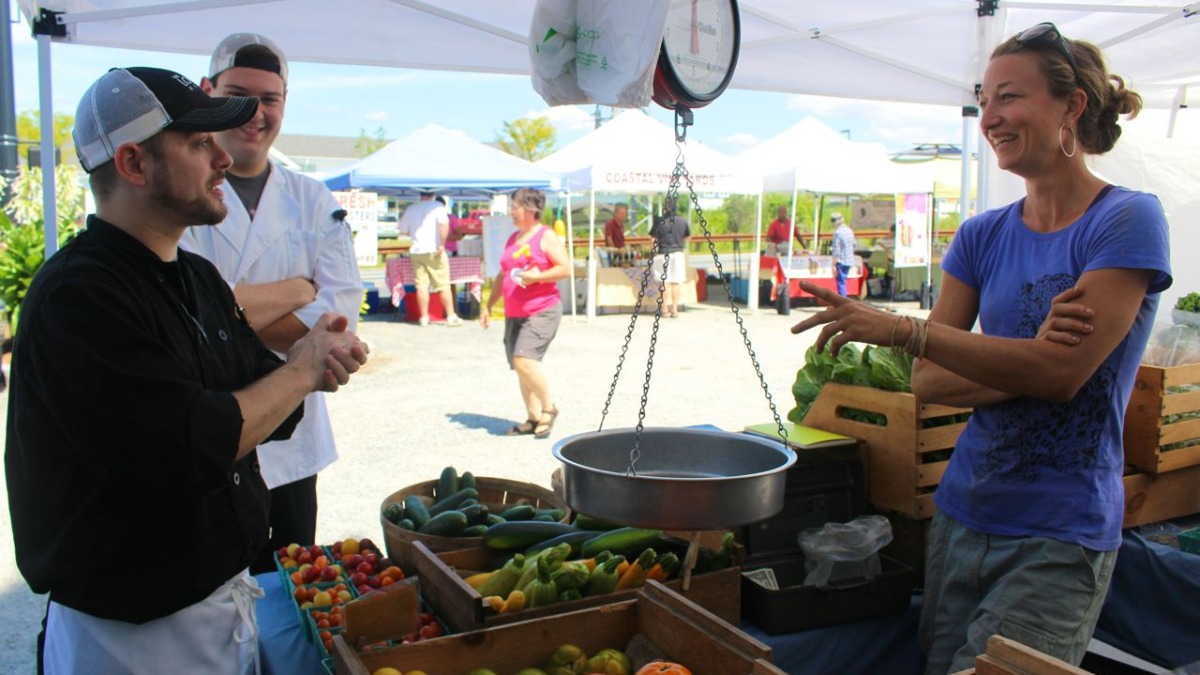 at a weekly farmer's market with chef cutomers