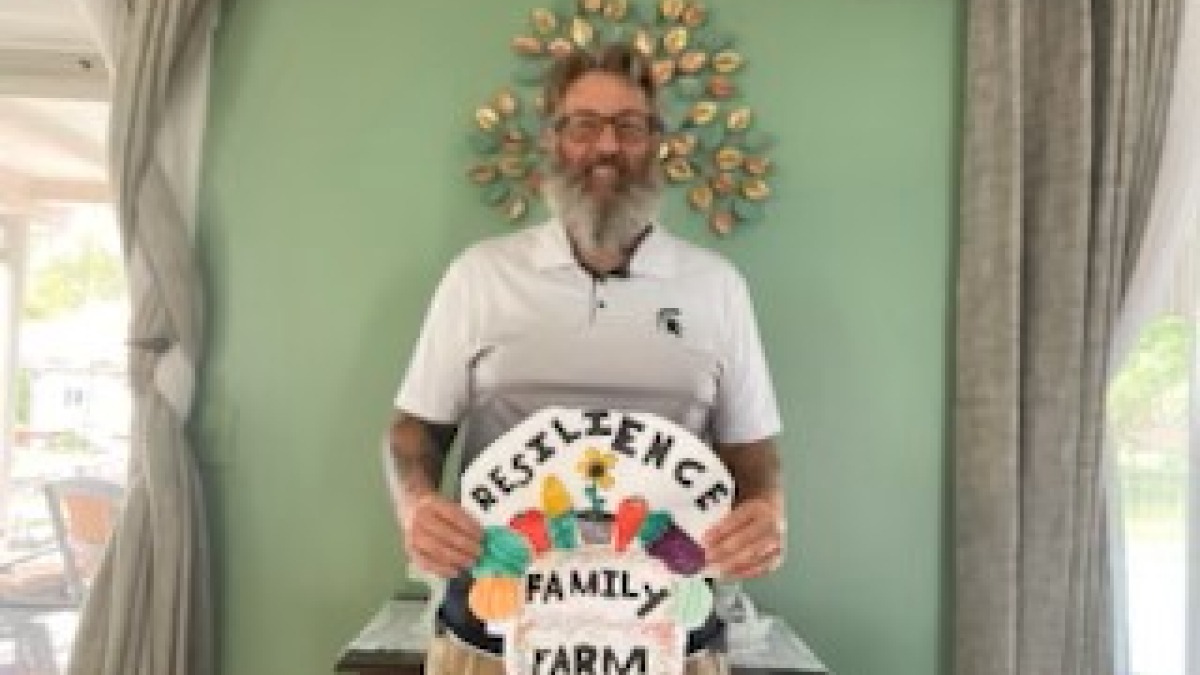 Me holding the logo my son designed for us.