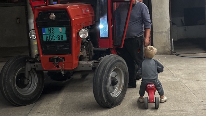 Helping out my uncle fix the lights on the tractor.