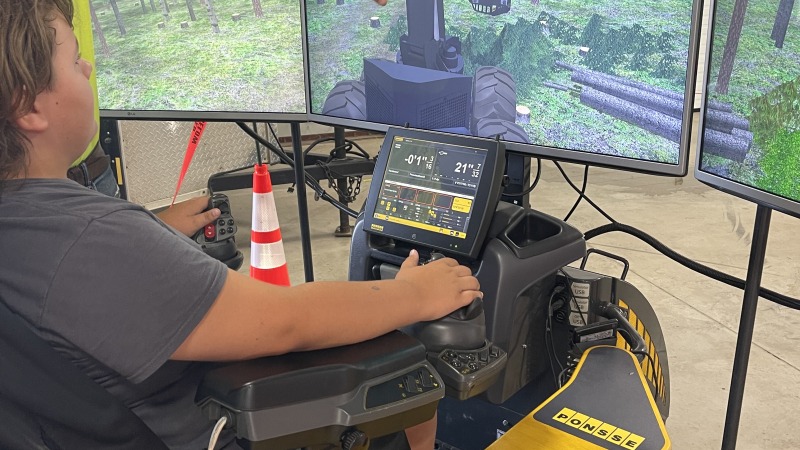 Branden Jr on a feller buncher simulator 