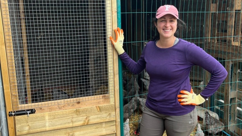 Stephanie with a door and door frame she built for a chicken coop. 