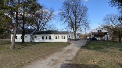 Ranch house and detached garage with loft as seen from the road.
